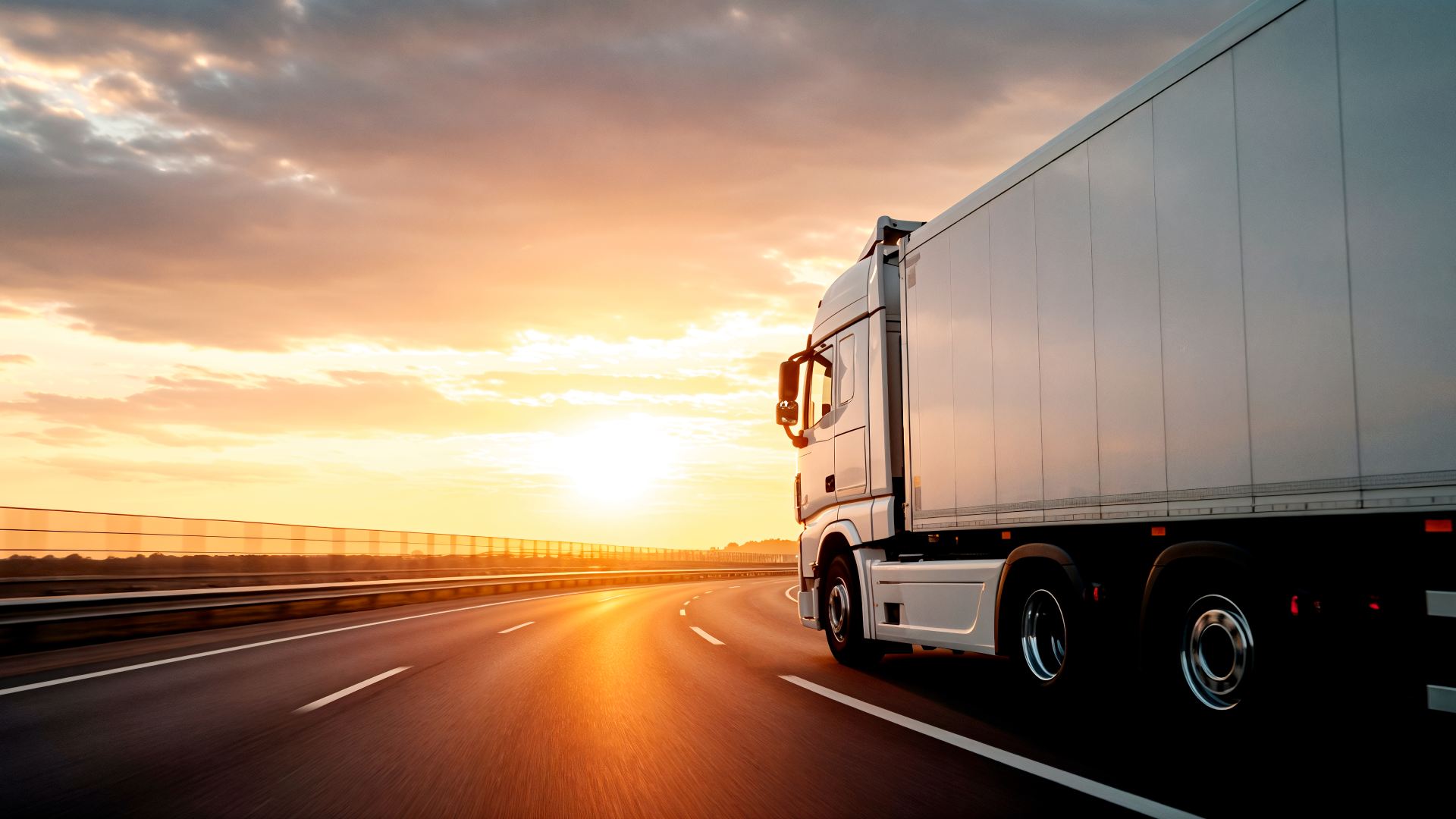 truck-driving-into-sunset-highway